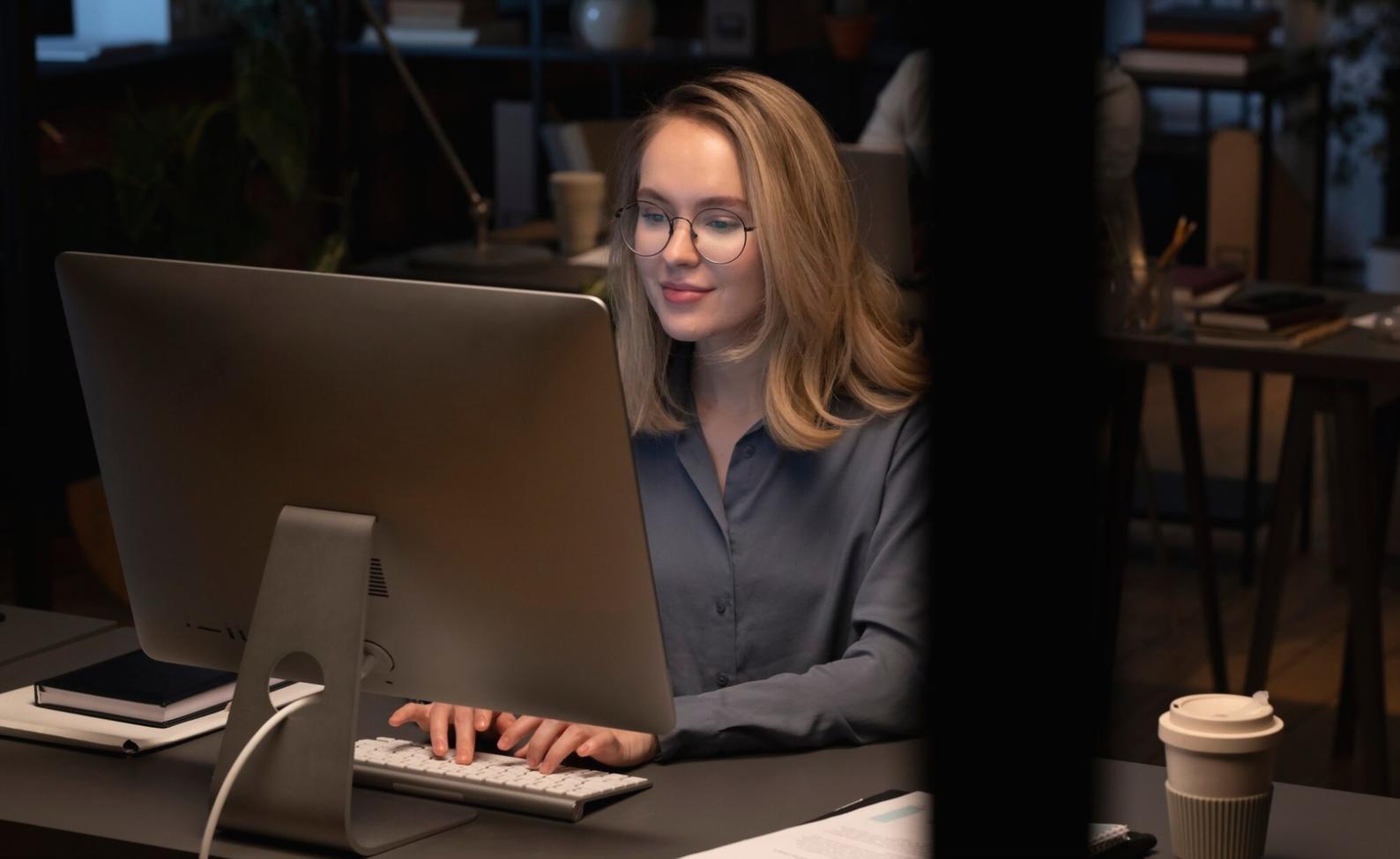 Student working on network configuration with laptop and networking equipment
